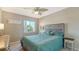 Bedroom with teal bedding and wood dresser at 6920 74Th Street E Cir, Bradenton, FL 34203