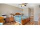 Main bedroom with wood flooring, ceiling fan, and ensuite bathroom at 6920 74Th Street E Cir, Bradenton, FL 34203