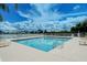 Refreshing community pool with lake views and lounge chairs at 6920 74Th Street E Cir, Bradenton, FL 34203