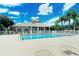 Community pool with clubhouse and plenty of lounge chairs at 6920 74Th Street E Cir, Bradenton, FL 34203