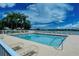 Relaxing community pool with lounge chairs and lake view at 6920 74Th Street E Cir, Bradenton, FL 34203