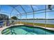 Lush pool area with lake view and screened enclosure at 6920 74Th Street E Cir, Bradenton, FL 34203