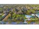 Aerial view of a vacant lot next to a modern home, surrounded by lush greenery at 6939 Bee Ridge Rd, Sarasota, FL 34241