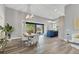 Open concept dining area with light wood table and modern chairs at 6939 Bee Ridge Rd, Sarasota, FL 34241