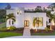 Modern home exterior at dusk with palm trees and landscaping at 6939 Bee Ridge Rd, Sarasota, FL 34241