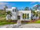 Modern white stucco home with palm trees and circular driveway at 6939 Bee Ridge Rd, Sarasota, FL 34241