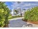 Modern white stucco house with circular turret and palm trees, long driveway at 6939 Bee Ridge Rd, Sarasota, FL 34241