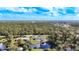 An aerial view of the house with a pond and many trees surrounding the home at 712 N Elm St, Englewood, FL 34223