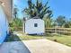 Charming backyard with a storage shed, concrete patio, and a wooden fence at 712 N Elm St, Englewood, FL 34223