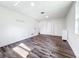 Bright bedroom featuring wood-look floors, white walls, and multiple closets at 712 N Elm St, Englewood, FL 34223