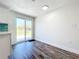 Dining area with sliding glass doors, neutral walls, and wood-look flooring at 712 N Elm St, Englewood, FL 34223