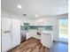 Bright kitchen with white cabinets, stainless steel appliances, and lovely backsplash tiling at 712 N Elm St, Englewood, FL 34223