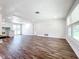 Bright living room with modern flooring, natural light, and a glimpse into the adjacent kitchen at 712 N Elm St, Englewood, FL 34223