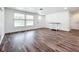 Spacious and well-lit living room with modern flooring, white painted walls, and a large window at 712 N Elm St, Englewood, FL 34223