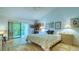 Bedroom with queen bed and access to balcony at 7610 Fairway Woods Dr # 205, Sarasota, FL 34238