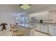 Kitchen with granite island and white cabinetry at 7610 Fairway Woods Dr # 205, Sarasota, FL 34238