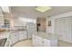 Kitchen with granite counters, white cabinets and island at 7610 Fairway Woods Dr # 205, Sarasota, FL 34238