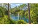 Tranquil pond view with lush greenery and fountain at 7610 Fairway Woods Dr # 205, Sarasota, FL 34238