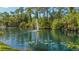 Serene pond with fountain and lily pads at 7610 Fairway Woods Dr # 205, Sarasota, FL 34238