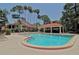 Community pool with a covered patio area at 7610 Fairway Woods Dr # 205, Sarasota, FL 34238