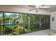 Screened balcony overlooking a pond and lush landscape at 7610 Fairway Woods Dr # 205, Sarasota, FL 34238