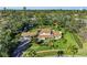 Expansive aerial view of the home featuring lush greenery and meticulous landscaping at 7820 Seville Cir, Bradenton, FL 34209