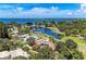 Aerial view of waterfront home with screened pool, lush trees, and nearby canal access at 7820 Seville Cir, Bradenton, FL 34209