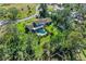 Aerial view of the backyard with a pool, lush greenery and tall trees at 7820 Seville Cir, Bradenton, FL 34209