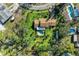 Aerial view of the house showing a sparkling pool and mature trees at 7820 Seville Cir, Bradenton, FL 34209