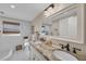 Bathroom featuring a double sink with granite countertops, tiled floors and a window at 7820 Seville Cir, Bradenton, FL 34209