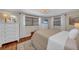 Bedroom featuring hardwood floors, white dressers, and natural light at 7820 Seville Cir, Bradenton, FL 34209