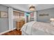 Bedroom featuring hardwood floors, a TV, and neutral gray paint at 7820 Seville Cir, Bradenton, FL 34209