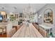 Charming dining room with an extra long rustic wood table and elegant chandelier at 7820 Seville Cir, Bradenton, FL 34209