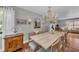 Charming dining room features a rustic wood table, elegant chandelier, and bright natural light at 7820 Seville Cir, Bradenton, FL 34209