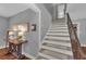 Inviting hallway featuring a staircase, hardwood floors, and stylish decor at 7820 Seville Cir, Bradenton, FL 34209