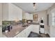 Bright kitchen featuring white cabinetry, neutral countertops, and stylish tiled backsplash at 7820 Seville Cir, Bradenton, FL 34209