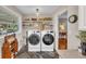 Well-lit laundry room with modern washer and dryer, decorative accents, and convenient shelving at 7820 Seville Cir, Bradenton, FL 34209