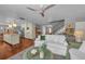 Bright living room features hardwood floors, white sofa, and view into the open kitchen at 7820 Seville Cir, Bradenton, FL 34209