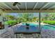 Inviting pool patio boasts an outdoor dining area and clear view of the sparkling pool and lush landscaping at 7820 Seville Cir, Bradenton, FL 34209