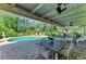 Charming pool patio offers a tranquil retreat with dining area, lounge seating, and clear views of the refreshing pool at 7820 Seville Cir, Bradenton, FL 34209