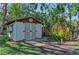 Charming shed with double doors, window boxes, and professional landscaping at 7820 Seville Cir, Bradenton, FL 34209