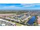 Wide aerial showcasing community, lake, and surrounding landscape at 9367 Hawk Nest Ln, North Port, FL 34287