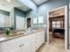 Double vanity bathroom with view of bedroom and glass block shower at 9367 Hawk Nest Ln, North Port, FL 34287