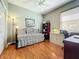 Bedroom with daybed, wood floors, and built-in shelving at 9367 Hawk Nest Ln, North Port, FL 34287