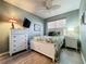 Bright bedroom with white dresser and tropical bedding at 9367 Hawk Nest Ln, North Port, FL 34287