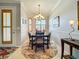 Elegant dining area with a wood table and chandelier at 9367 Hawk Nest Ln, North Port, FL 34287