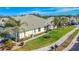 View of home's exterior showcasing a side yard and palm trees at 9367 Hawk Nest Ln, North Port, FL 34287