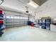 Garage with overhead door and ample storage shelving at 9367 Hawk Nest Ln, North Port, FL 34287