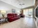 Relaxing living room with red leather furniture and built-ins at 9367 Hawk Nest Ln, North Port, FL 34287