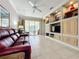 Living room with built-in shelving and red leather sofa at 9367 Hawk Nest Ln, North Port, FL 34287